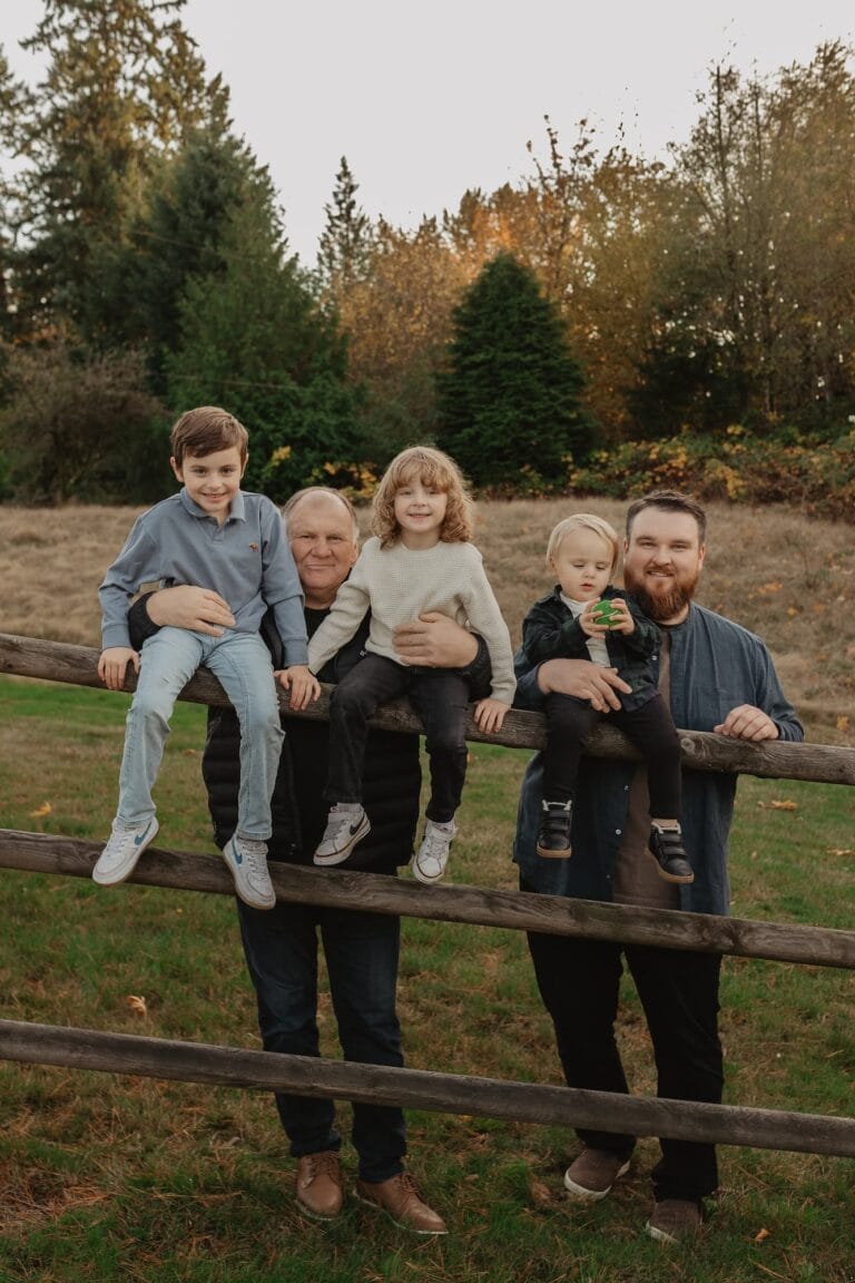 Father and son team behind SANDA with the kids stadning in front of an Autumn PNW forest backdrop.