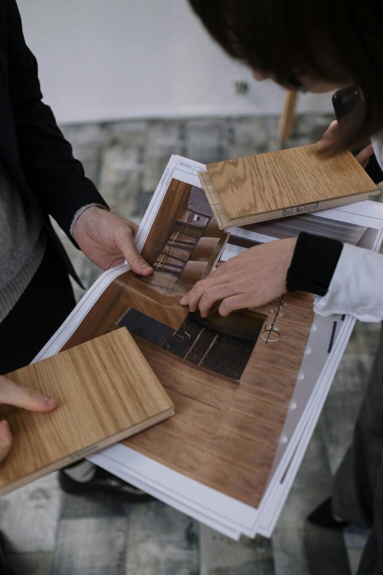 Closeup of two people looking at wood swatches together.